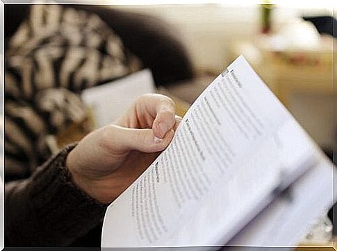 Hand resting on the page of a book