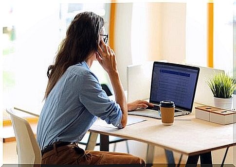 Woman from behind sitting in front of the computer