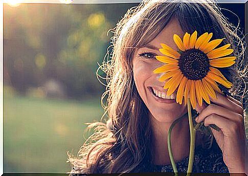 Happy woman with a sunflower