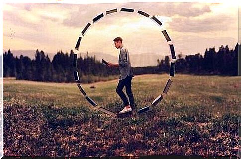 Boy inside a circle made of books