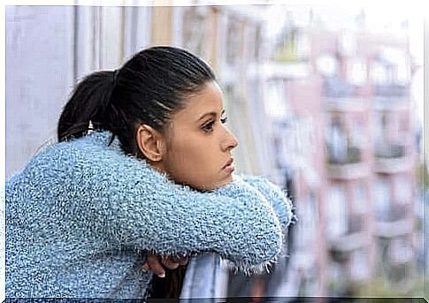 Woman thinking looking out to the balcony.