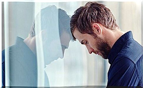 Boy with his head resting on a glass.