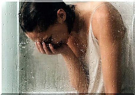 Woman crying in the shower.