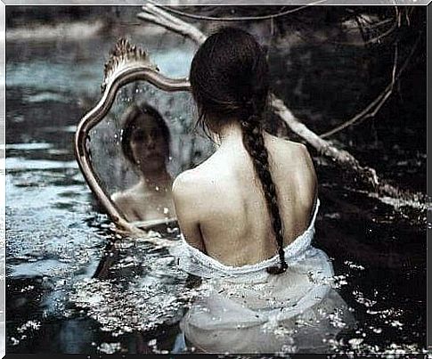 Woman in the water with a mirror