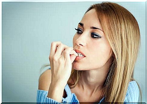 Woman biting her nails.