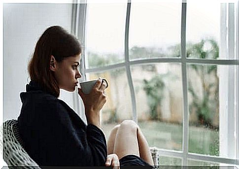 Quarantine, thoughtful girl sitting in front of the window