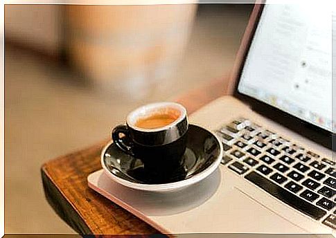 Cup of coffee on laptop