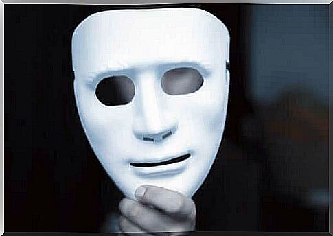 Person holding a white mask in hand