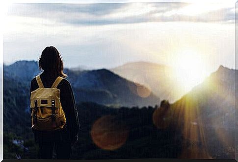 Woman with backpack in the mountains