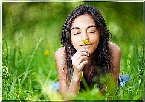 Girl sniffing a flower