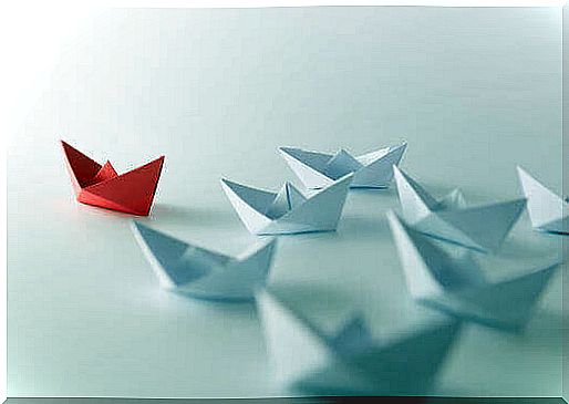 White paper boats follow red boat