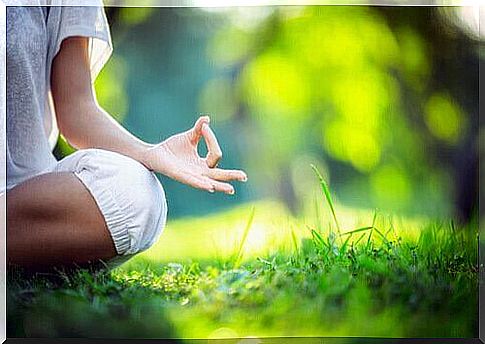 Woman meditating on the grass