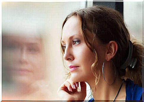 Woman looks out of the window