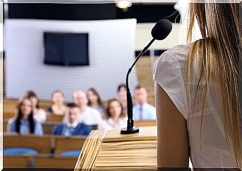 Woman with microphone and audience