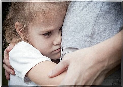 Angry little girl hugs her mother