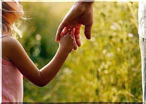 Hand between parent and daughter