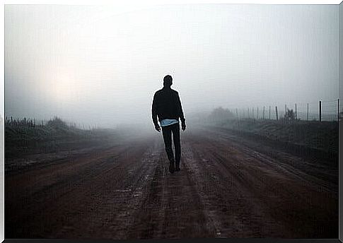 Man walks in the fog.