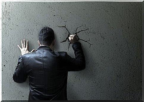 Self-destructive man punching the wall