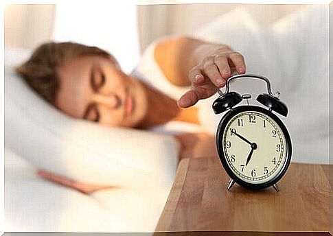 Woman unplugging the alarm clock