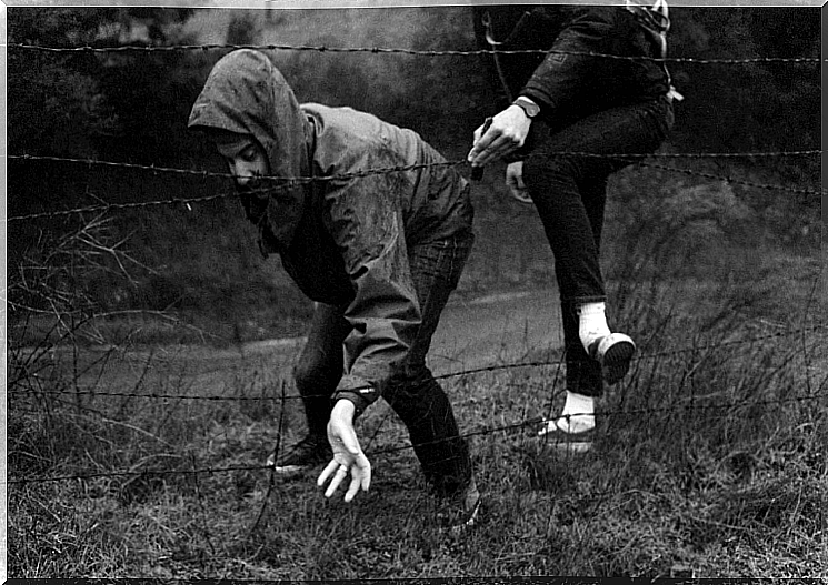 Person running away from the barbed wire