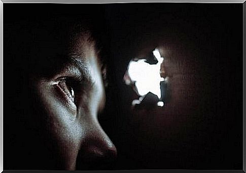 Child looking out of a hole