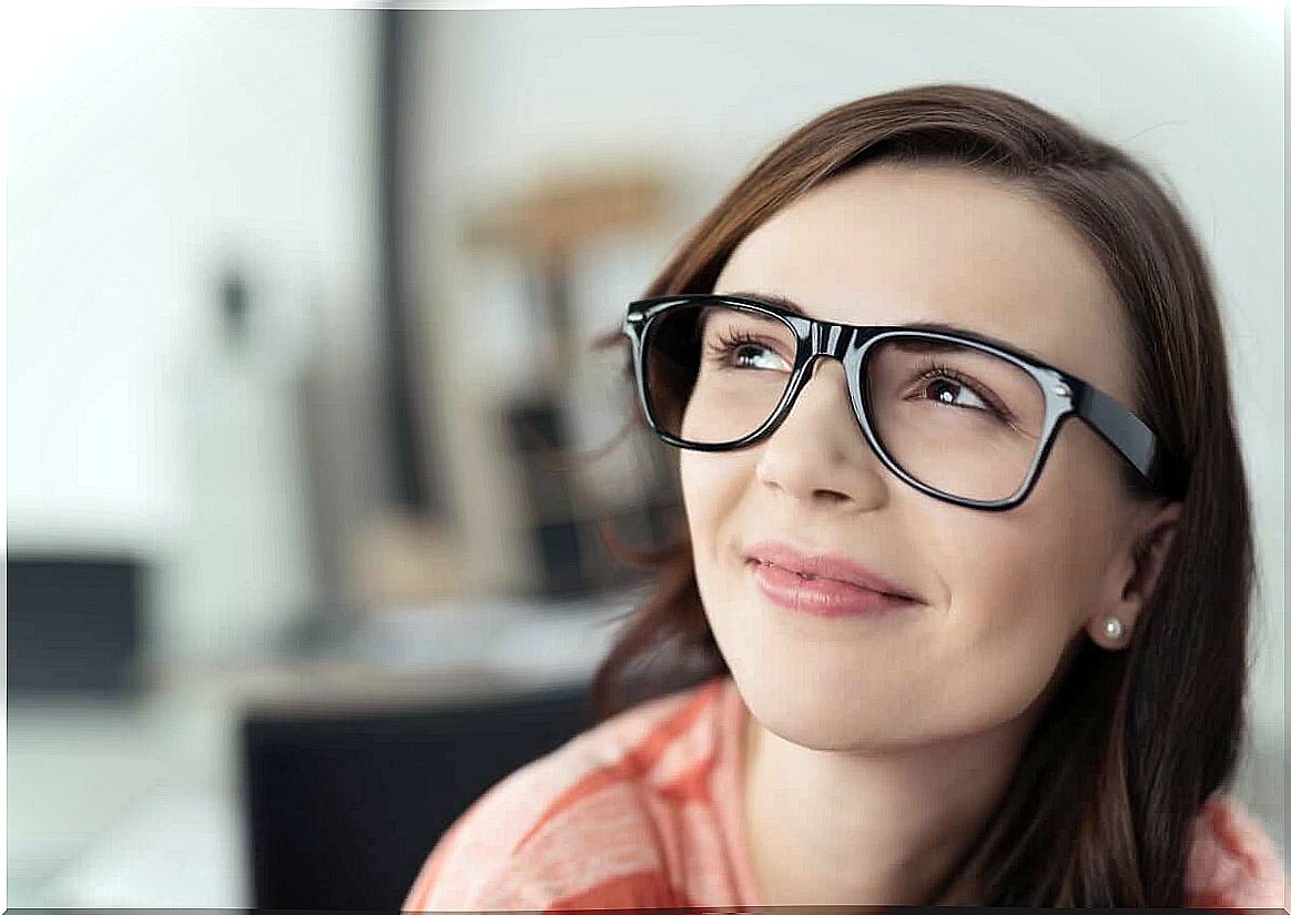 Smiling woman with glasses.