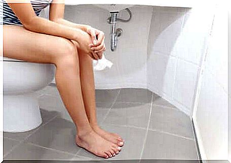 Woman sitting on the toilet.